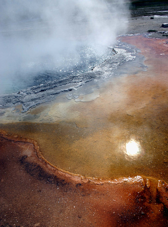 Sun reflection in a thermal spring, Yellowstone NP